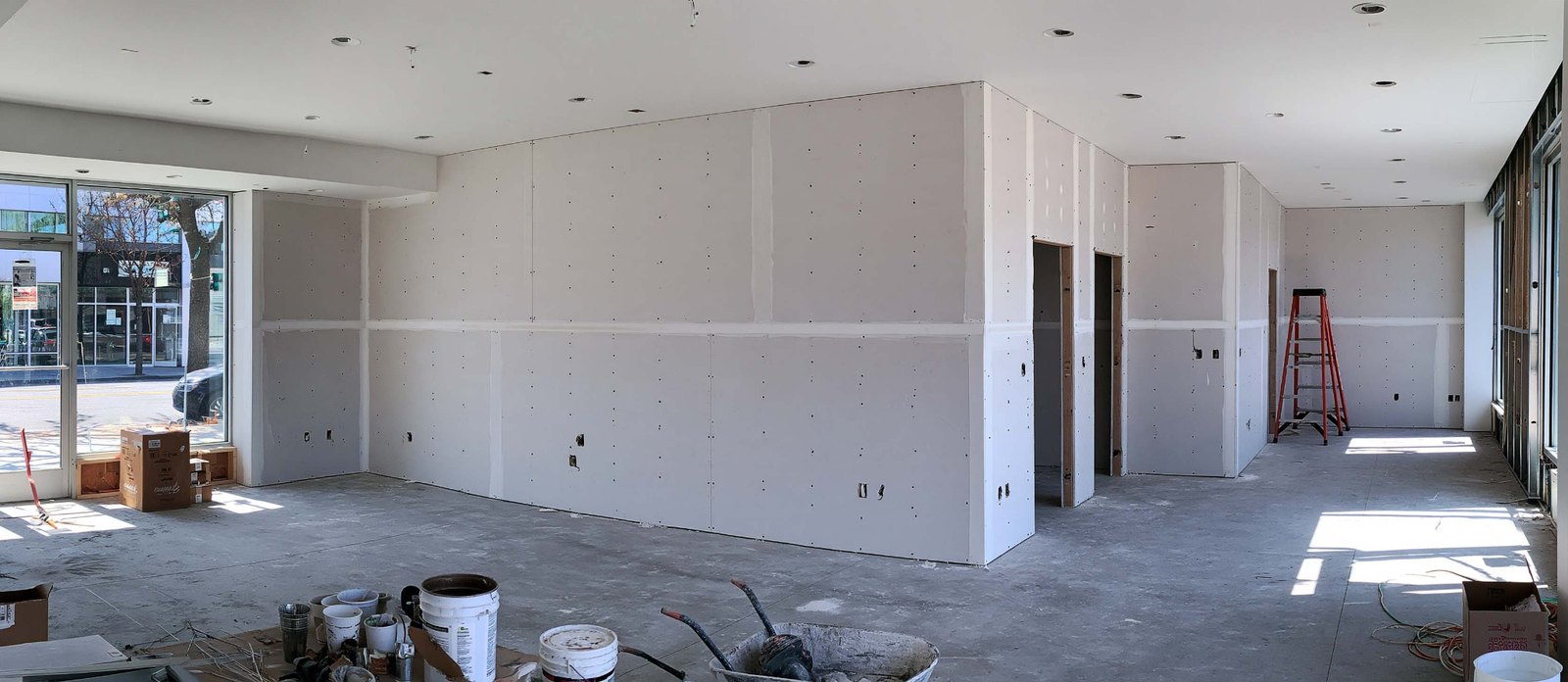 New drywall partitions in a commercial interior under construction.