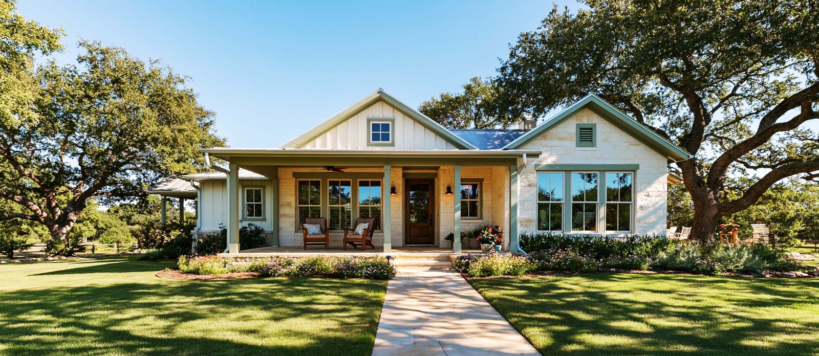 Illustrative limestone cottage with a sunny front porch and mature live oaks.